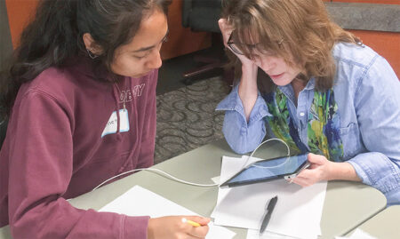 Teacher helping student prepare for college essay